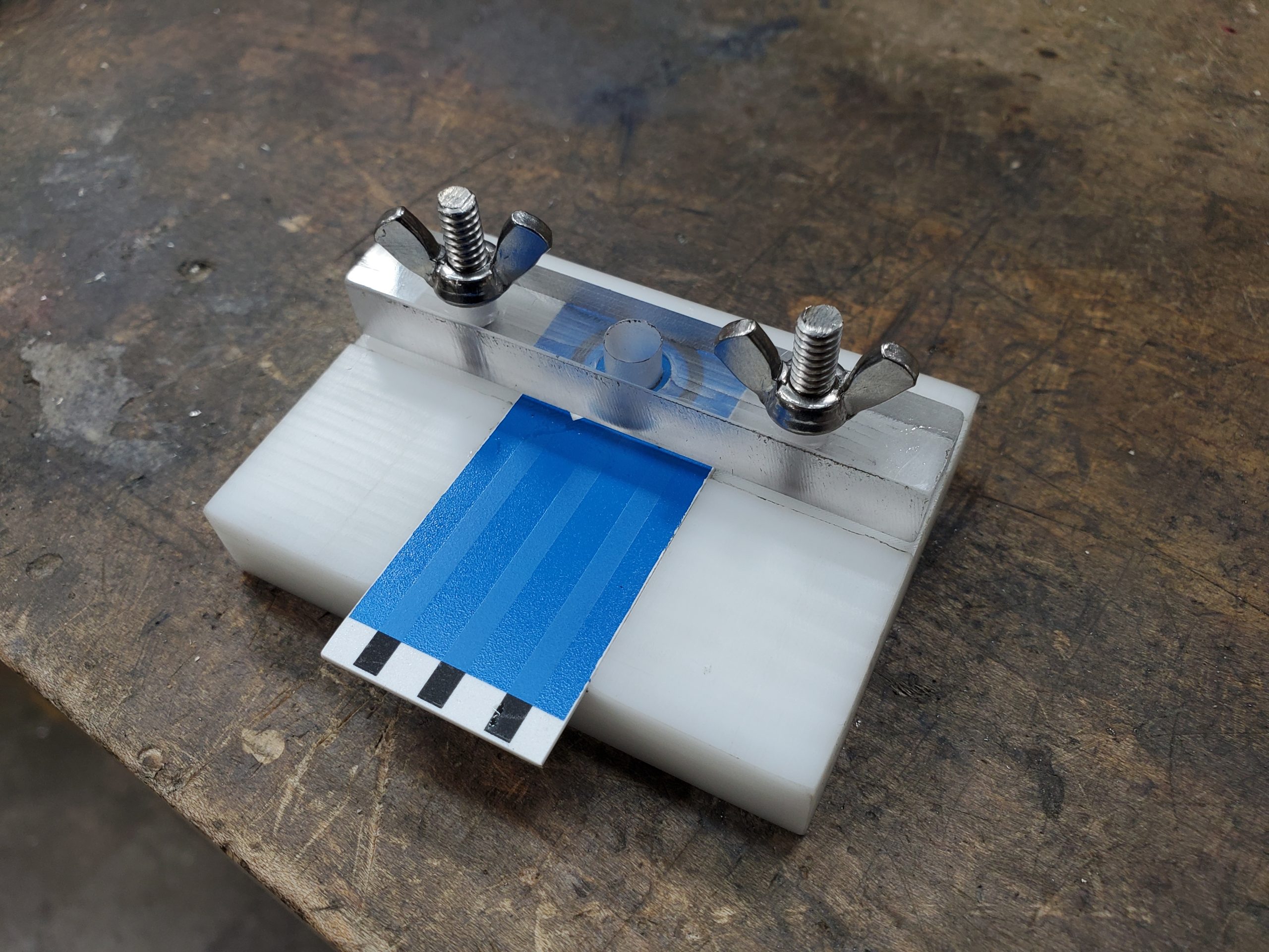 Fully assembled sample analysis fixture with the part held in its locating feature